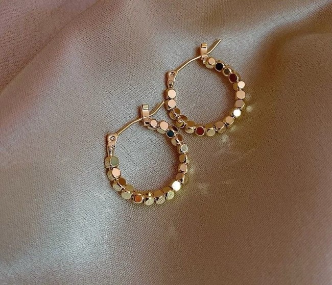 Golden earrings with circular design for women