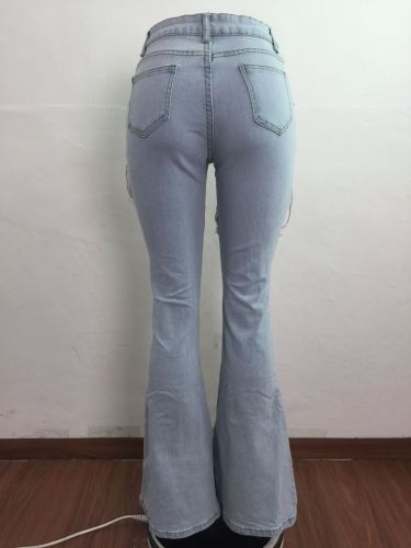 Cut torn holes and wash water to make old flared fashionable casual jeans A3272