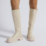 Small white boots with thick soles and high shafts are thinner than knees