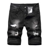 Perforated men's denim pants with many tattered jeans