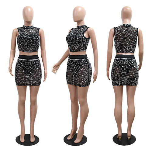 Sleeveless round neck top paired with hip hugging short skirt and rhinestone mesh two-piece set