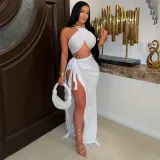 High slit tassel long skirt paired with strapless top and tie up two-piece set