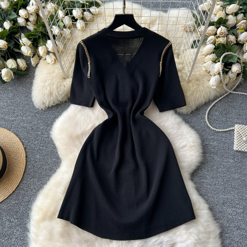 Knitted dress with metal breasted V-neck and waist cinched mid length design