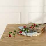 The living room dining table is decorated with flower arrangement and bonsai. New Chinese Spring Begonia flowers