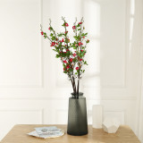 The living room dining table is decorated with flower arrangement and bonsai. New Chinese Spring Begonia flowers
