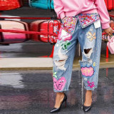 Distressed Denim Jeans with Strategic Rhinestone Embellishments