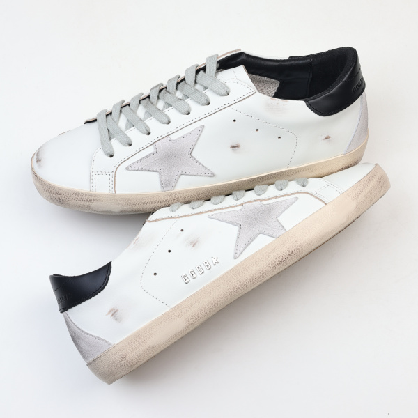 Golden G00se Super-Star trainers with black heels tab and metal stud lettering