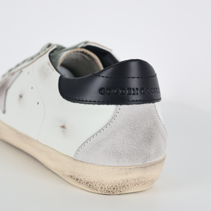 Golden G00se Super-Star trainers with black heels tab and metal stud lettering