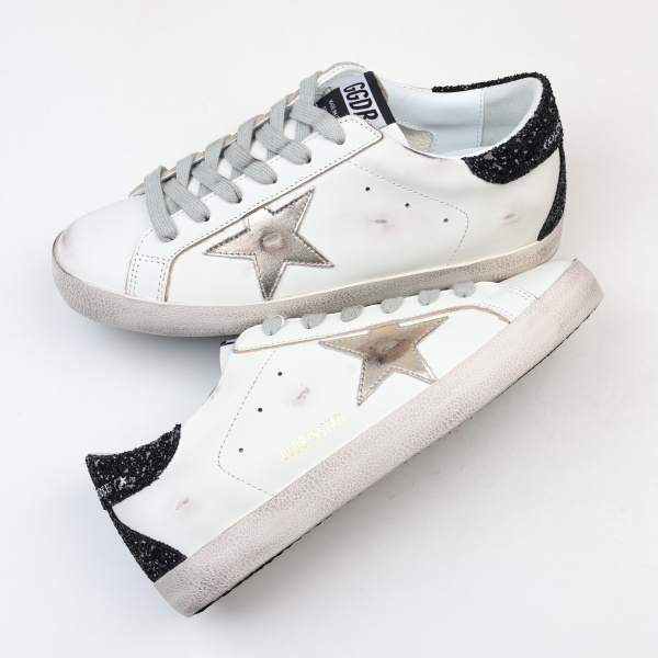Golden G00se Super-Star trainers with gold star and black glitter heels tab