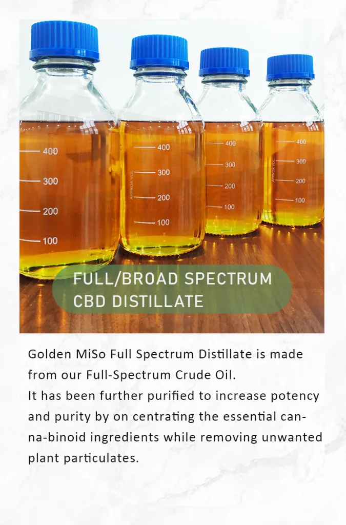 four bottles of golden oil on table