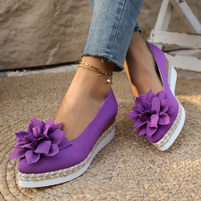 A Pair of Stylish And Comfortable Purple Lotus Flower Head Wedge Shoes with a Thick Sole, Pointed Toe, Made of Polyurethane And Jute, Perfect for Casual Wear.
