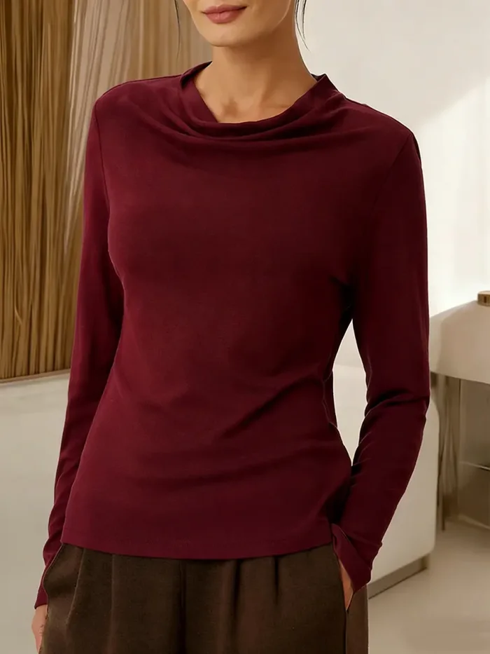 Women's solid color long-sleeved casual top with a draped neckline