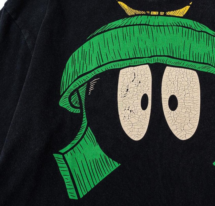 Green helmet cartoon character wash tee