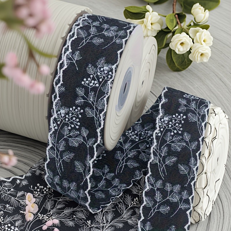 A Roll of Vintage Printed Denim Ribbon, 1. 57 Inches Wide And 2\u002F5 Yards Long, Featuring Solid Color Denim Edges with Floral Leaf Prints, Suitable for Any Holiday Gift Wrapping, DIY Bows, Headbands, Hats, And Home Decor Crafts.