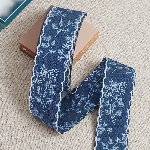 A Roll of Vintage Printed Denim Ribbon, 1. 57 Inches Wide And 2\u002F5 Yards Long, Featuring Solid Color Denim Edges with Floral Leaf Prints, Suitable for Any Holiday Gift Wrapping, DIY Bows, Headbands, Hats, And Home Decor Crafts.