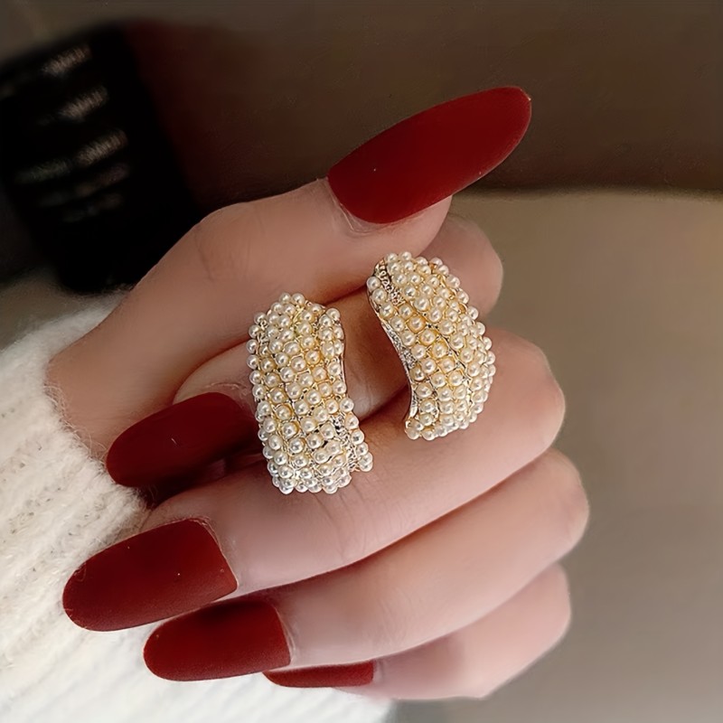 A Pair of Elegant And Minimalist Designer Earrings for Women, Featuring a Chic Pearl-Like Style.