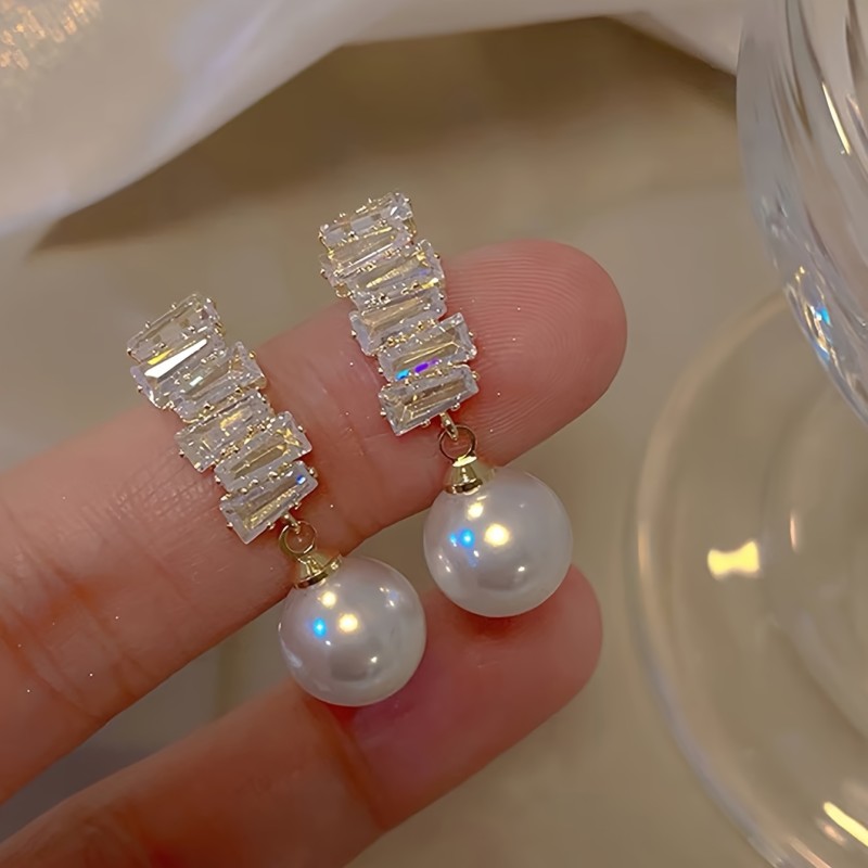 A Pair of Exquisite And Elegant Lightweight Luxury Drop Earrings for Women, Featuring Geometric Designs with Copper And Synthetic Zirconia Stones, Showcasing a Unique Fashion Sense.