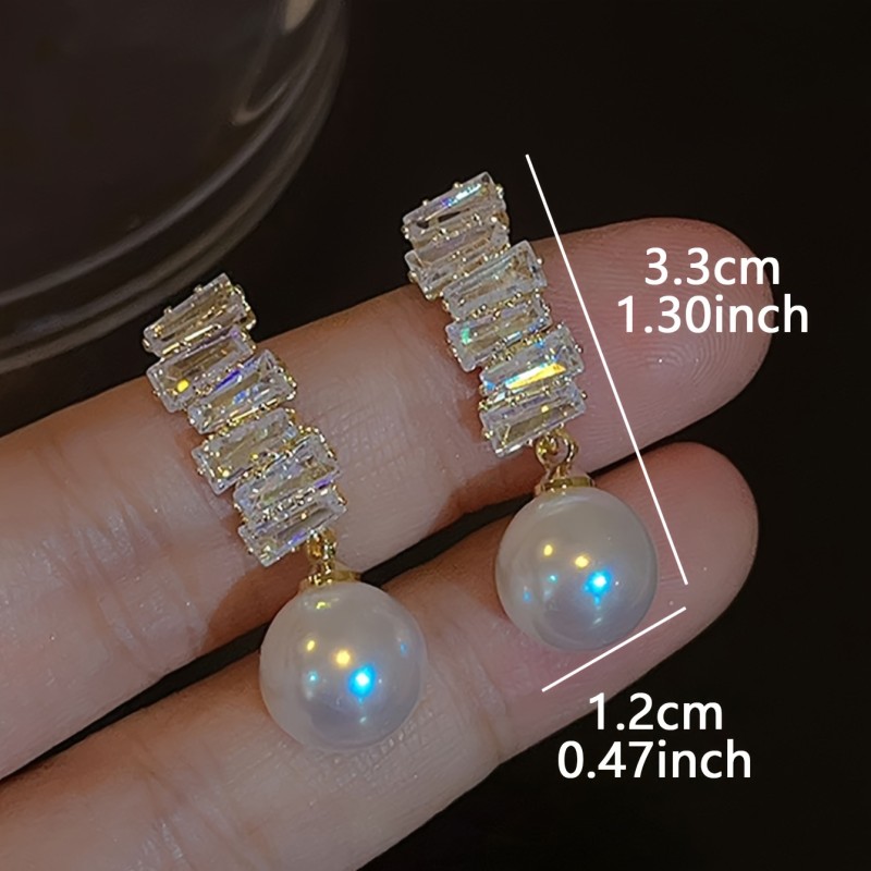 A Pair of Exquisite And Elegant Lightweight Luxury Drop Earrings for Women, Featuring Geometric Designs with Copper And Synthetic Zirconia Stones, Showcasing a Unique Fashion Sense.