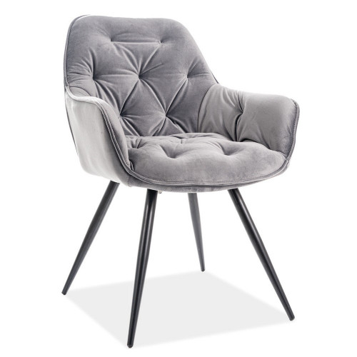 Light grey tufted velvet chair with metal legs and armrest