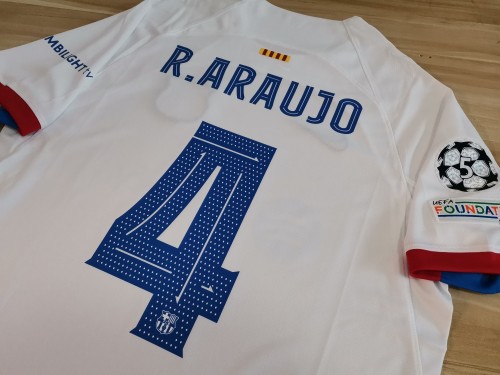 with UCL+Sleeve Sponor R.ARAUJO 4 Shirt for Fan Version 2023-2024 Barcelona Away White Soccer Jersey