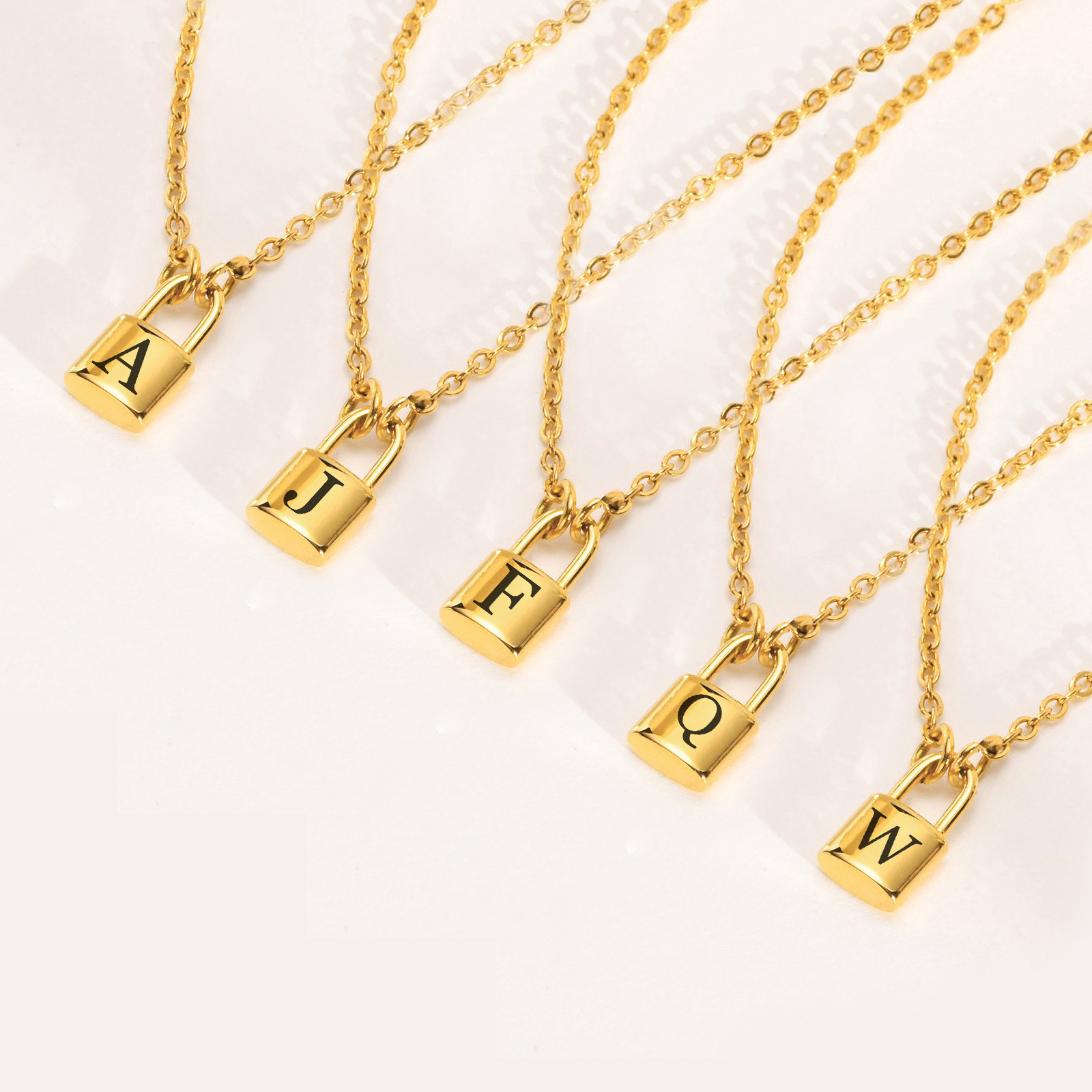 Gold tone initial padlock necklaces in different letter options